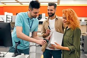 Electronics retail staff using tablets connected to Odoo system